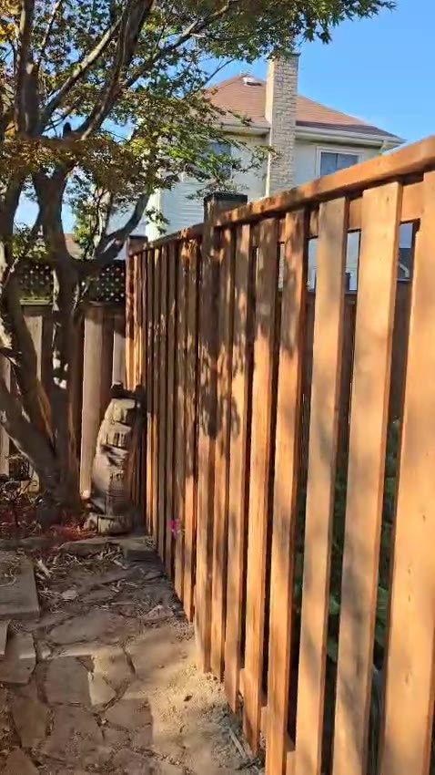 Wood privacy fence along a landscaped garden path